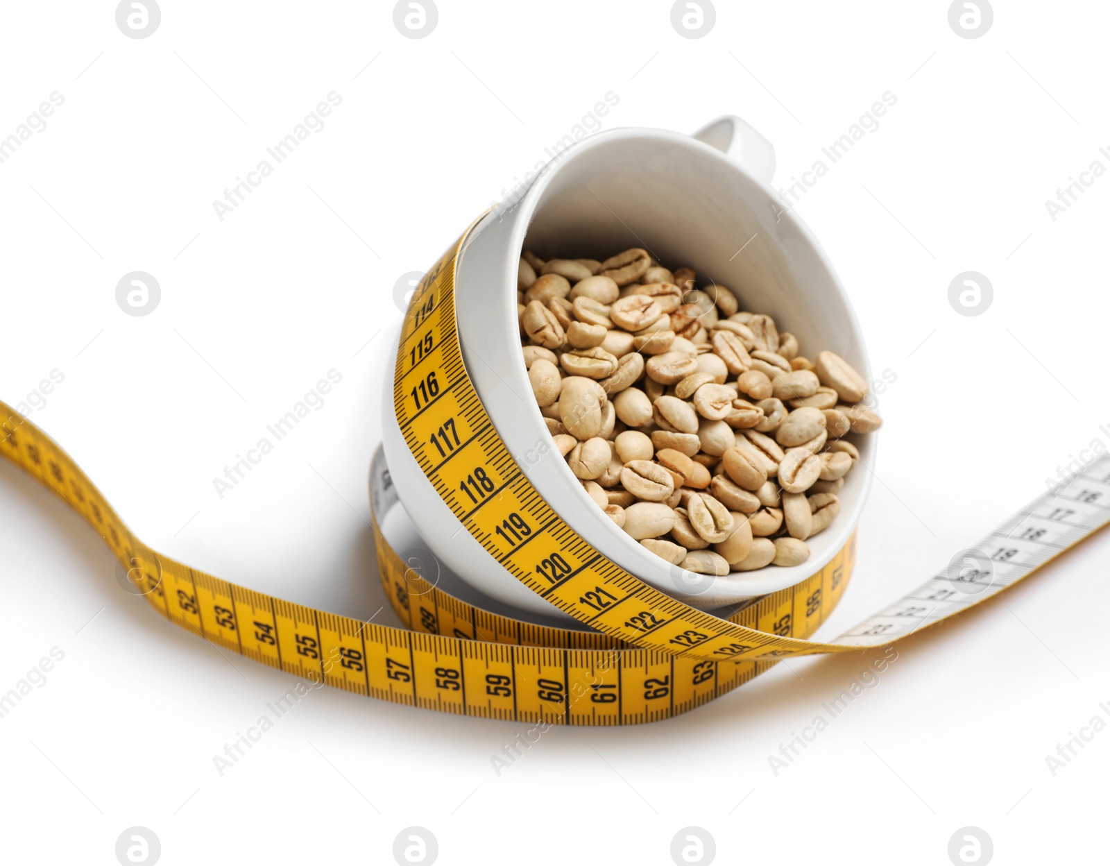 Photo of Cup with green coffee beans and measuring tape on white background