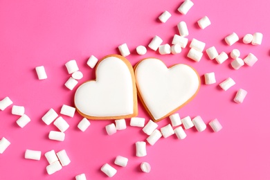 Photo of Flat lay composition with decorated heart shaped cookies on color background