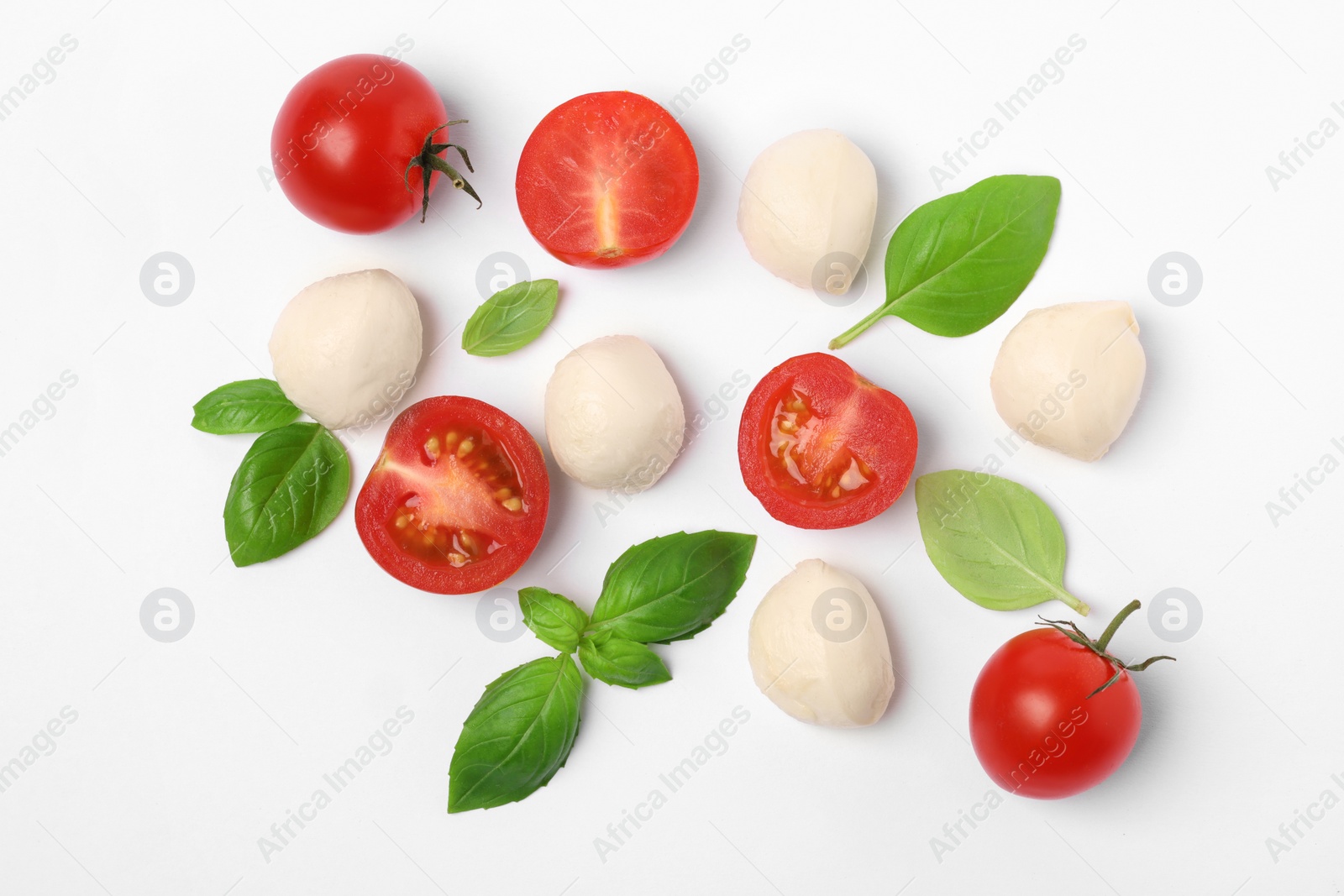 Photo of Mozzarella, tomatoes and basil on white background, flat lay. Caprese salad ingredients