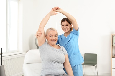 Physiotherapist working with patient in clinic. Rehabilitation therapy