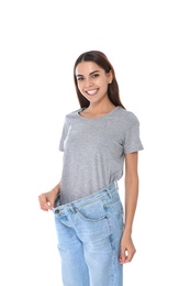 Slim woman in oversized jeans on white background. Weight loss