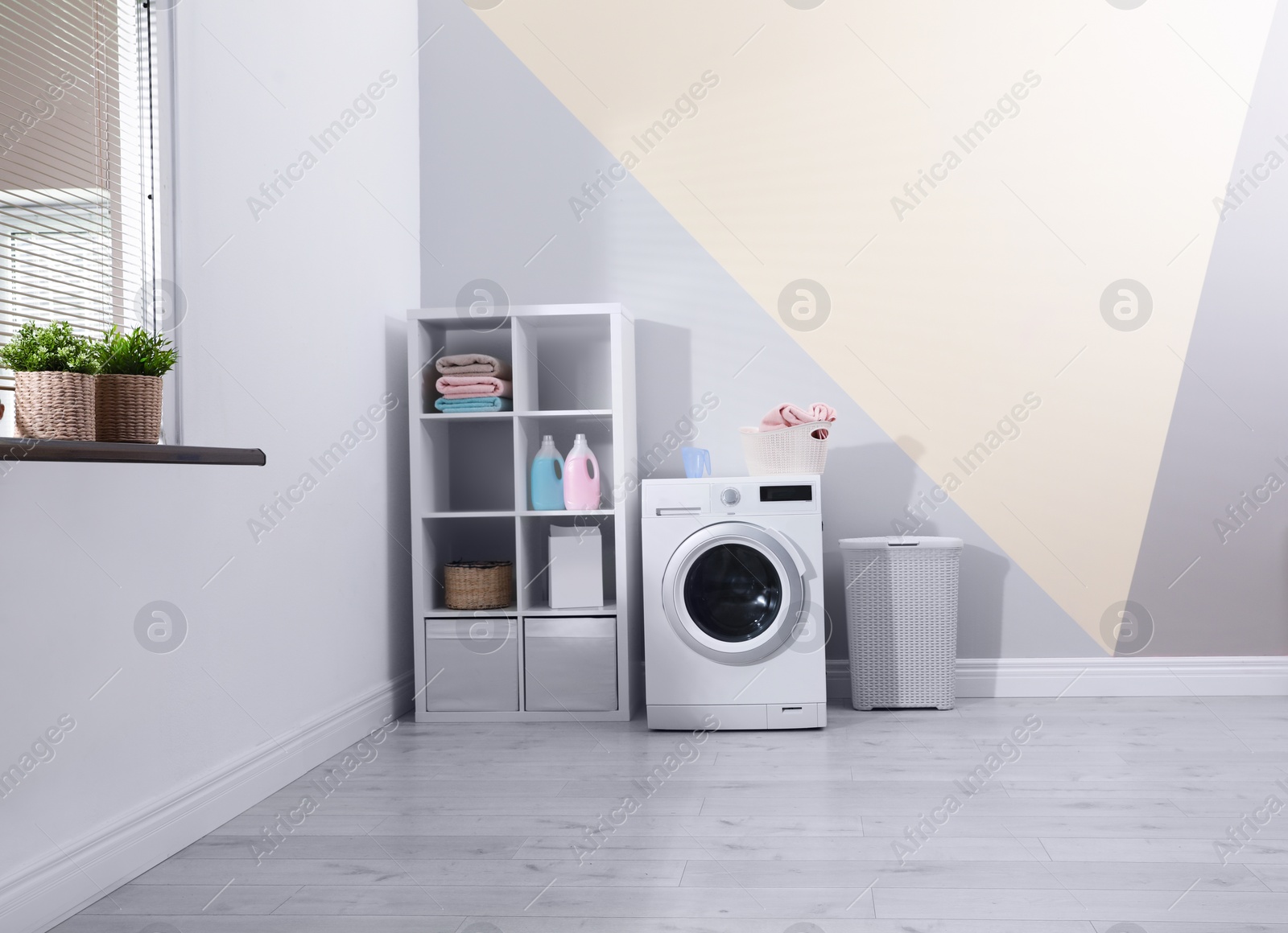 Photo of Modern washing machine in laundry room interior. Space for design