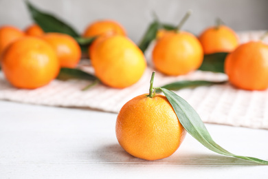 Fresh ripe tangerine on white wooden table