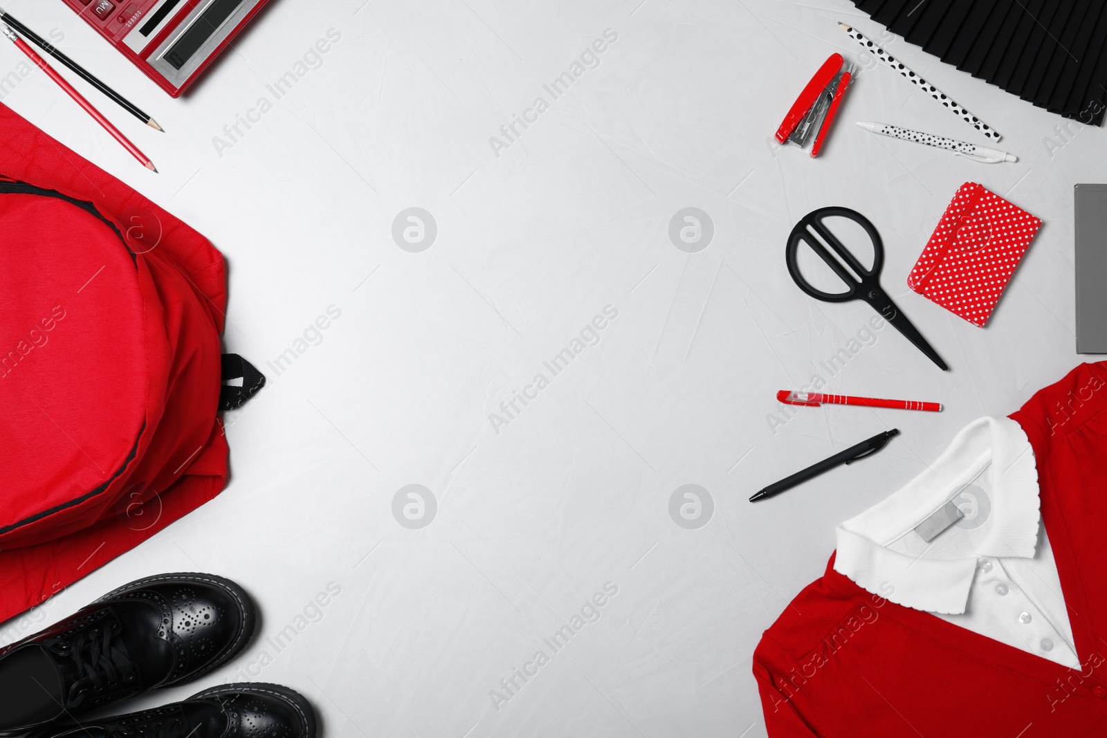 Photo of Flat lay composition with school uniform on light background. Space for text