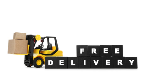 Toy forklift and cubes with words FREE DELIVERY isolated on white. Logistics and wholesale concept