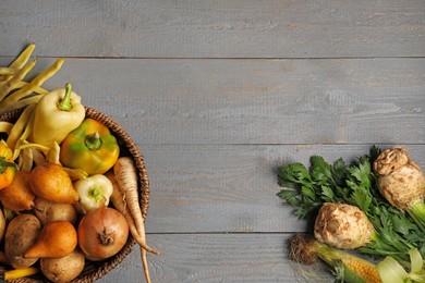 Different fresh ripe vegetables and fruits on grey wooden table, flat lay. Space for text