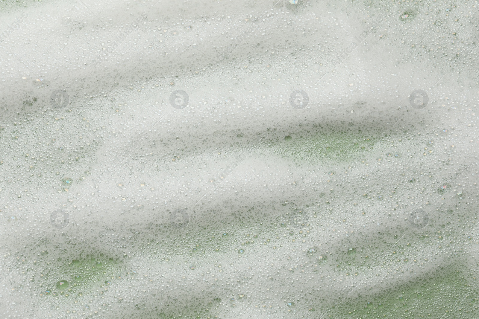 Photo of White washing foam on olive background, top view