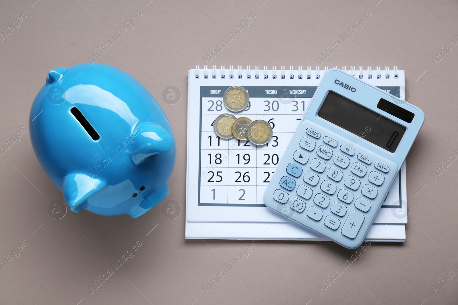 Photo of Flat lay composition with piggy bank and calculator on grey background