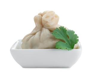 Photo of One tasty khinkali (dumpling) and parsley in bowl isolated on white. Georgian cuisine