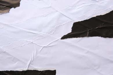 Photo of Texture of white and black ripped paper posters, closeup