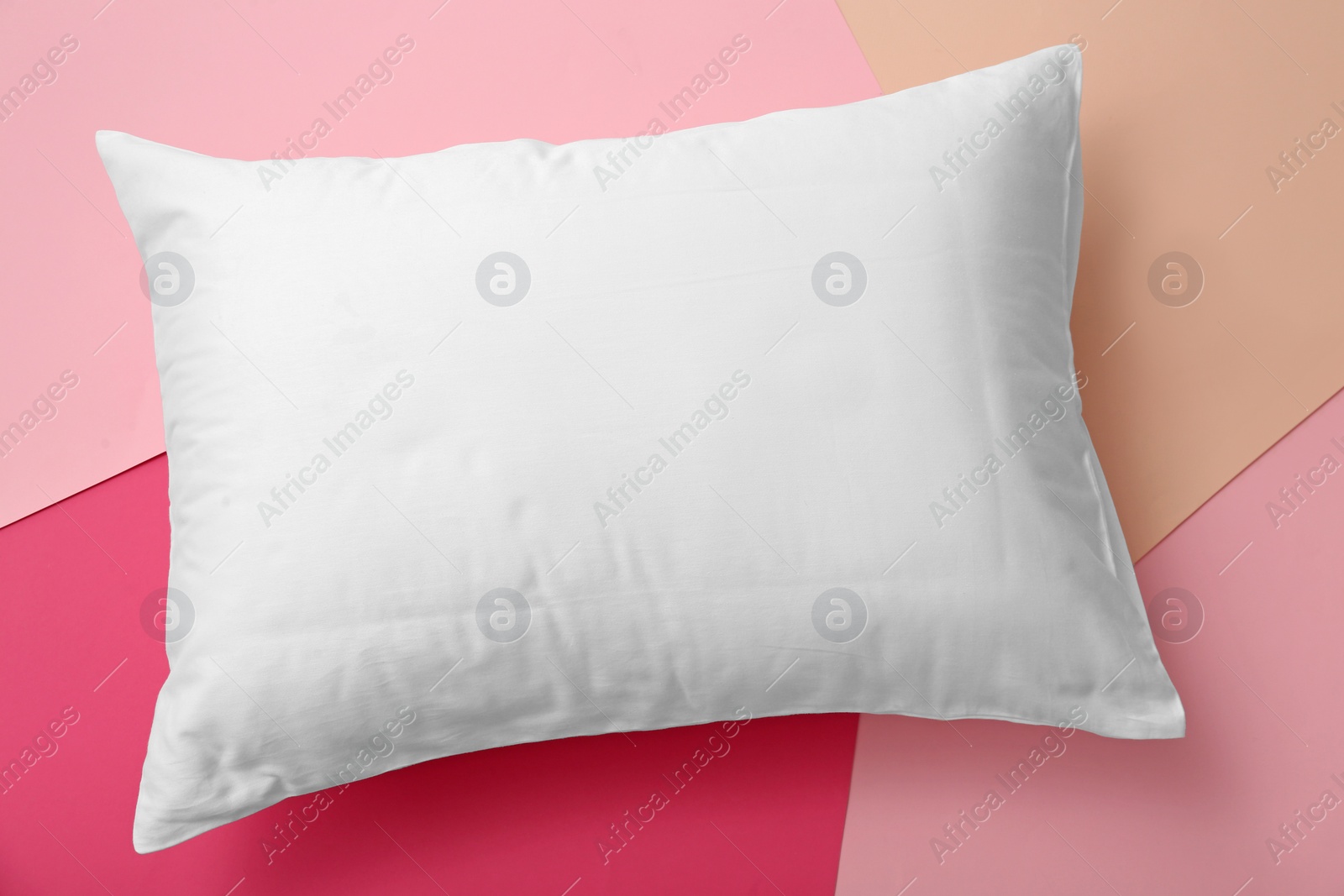 Photo of Soft bed pillow on color background, top view