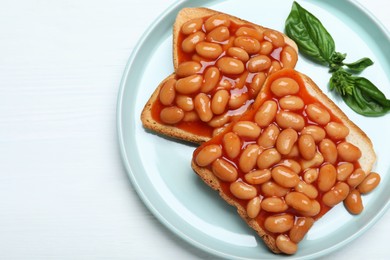 Photo of Toasts with delicious canned beans on white wooden table, top view