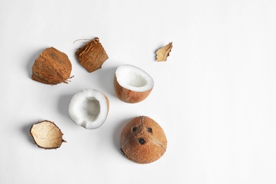 Ripe coconuts on white background, top view