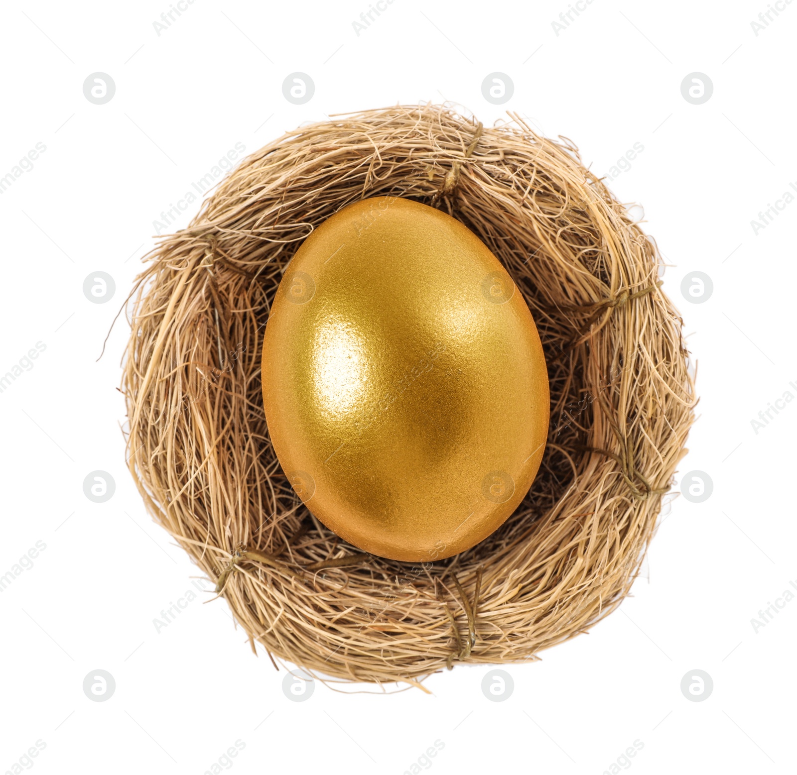 Photo of Shiny golden egg in nest on white background, top view
