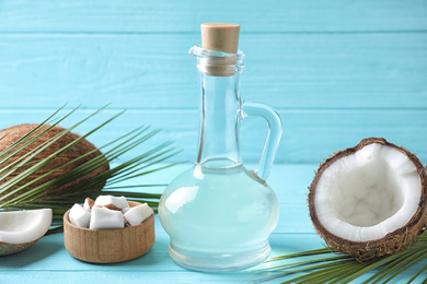 Photo of Composition with coconut oil on light blue wooden table