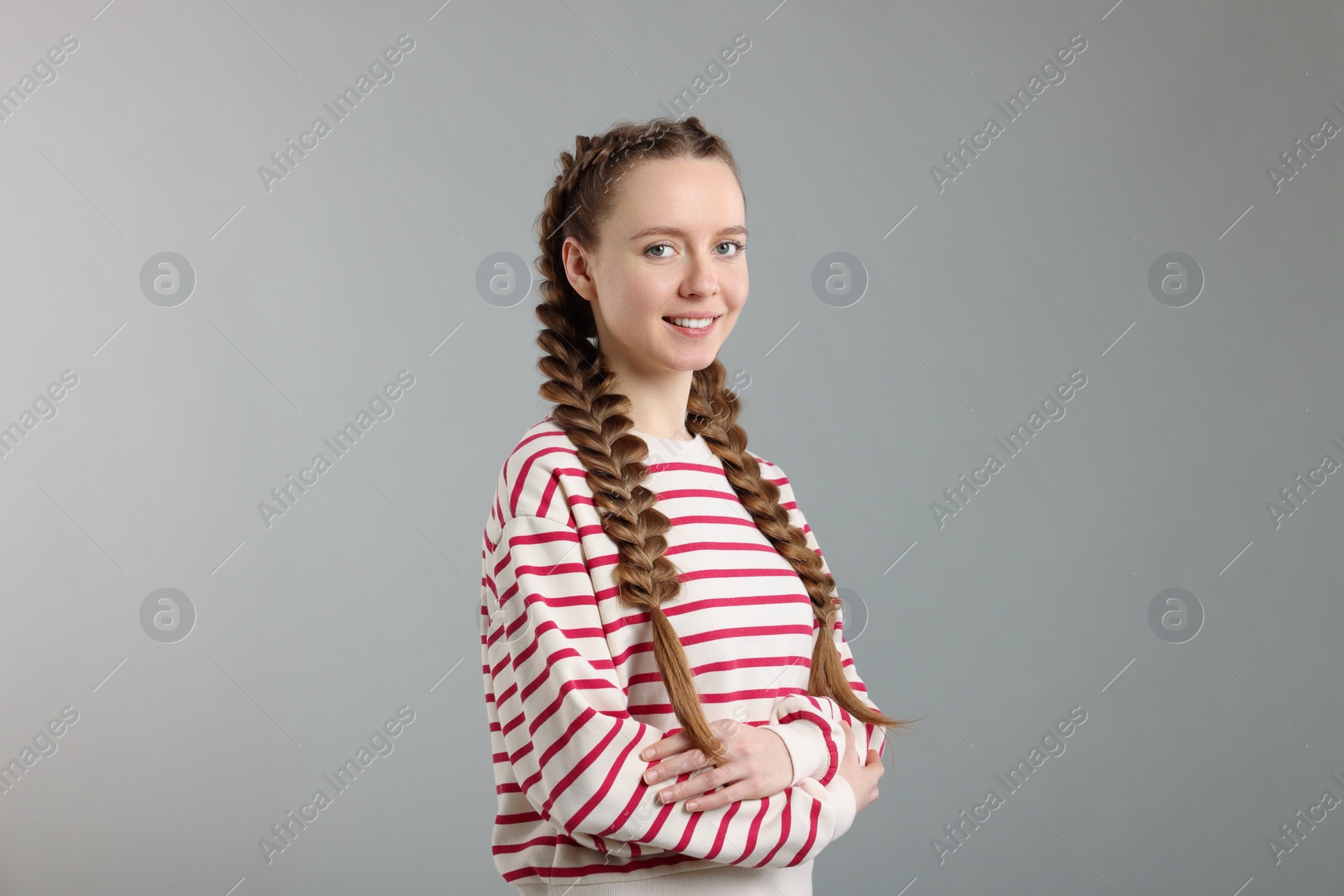 Photo of Woman with braided hair on grey background