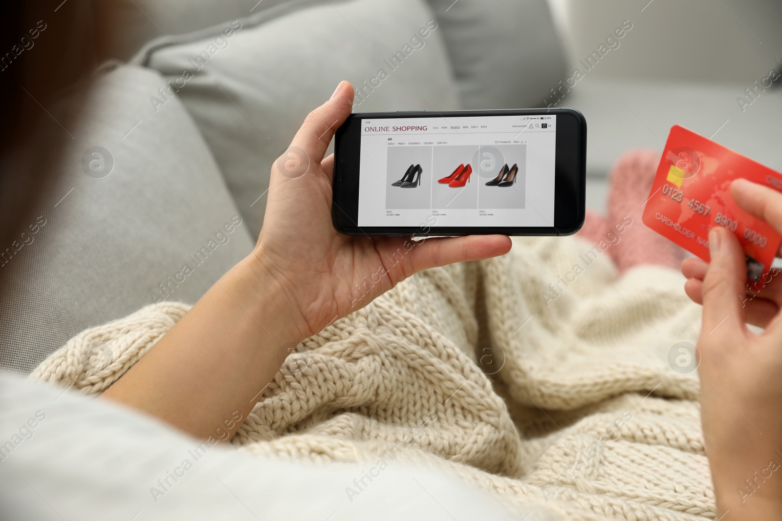 Photo of Woman with credit card using smartphone for online shopping indoors, closeup