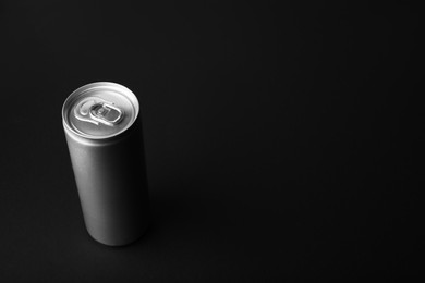 Photo of Can of energy drink on black background. Space for text