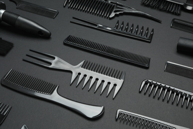 Composition with modern hair combs on black background