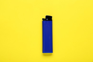 Photo of Stylish small pocket lighter on yellow background, top view