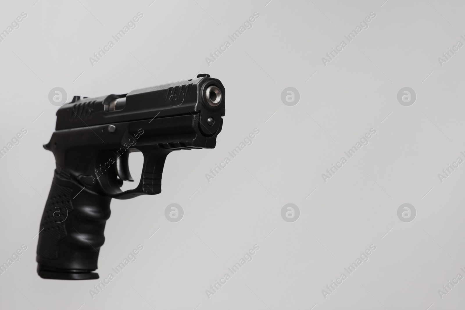 Photo of Standard handgun on light grey background. Semi-automatic pistol