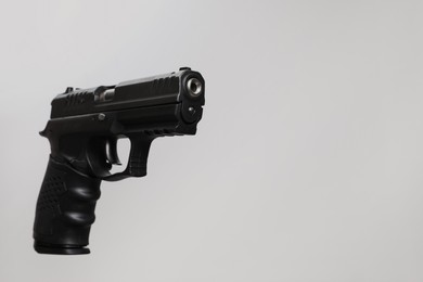 Standard handgun on light grey background. Semi-automatic pistol