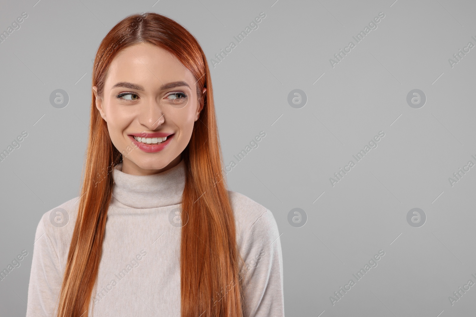 Photo of Portrait of beautiful young woman on light gray background, space for text