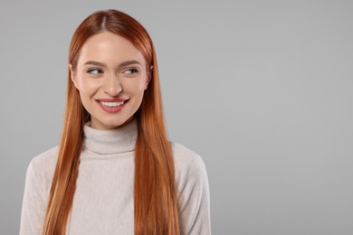 Portrait of beautiful young woman on light gray background, space for text