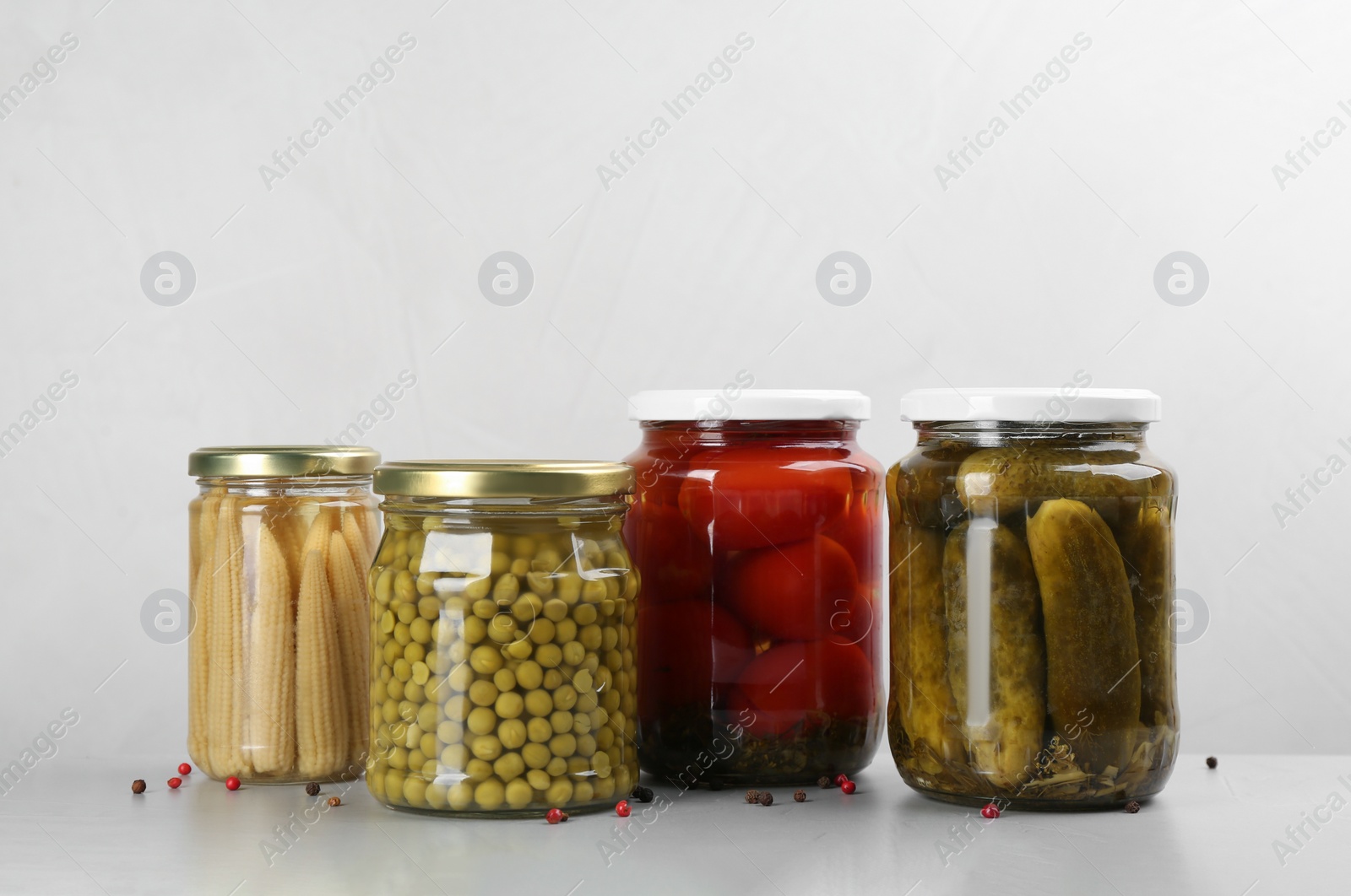 Photo of Jars of pickled vegetables on light table