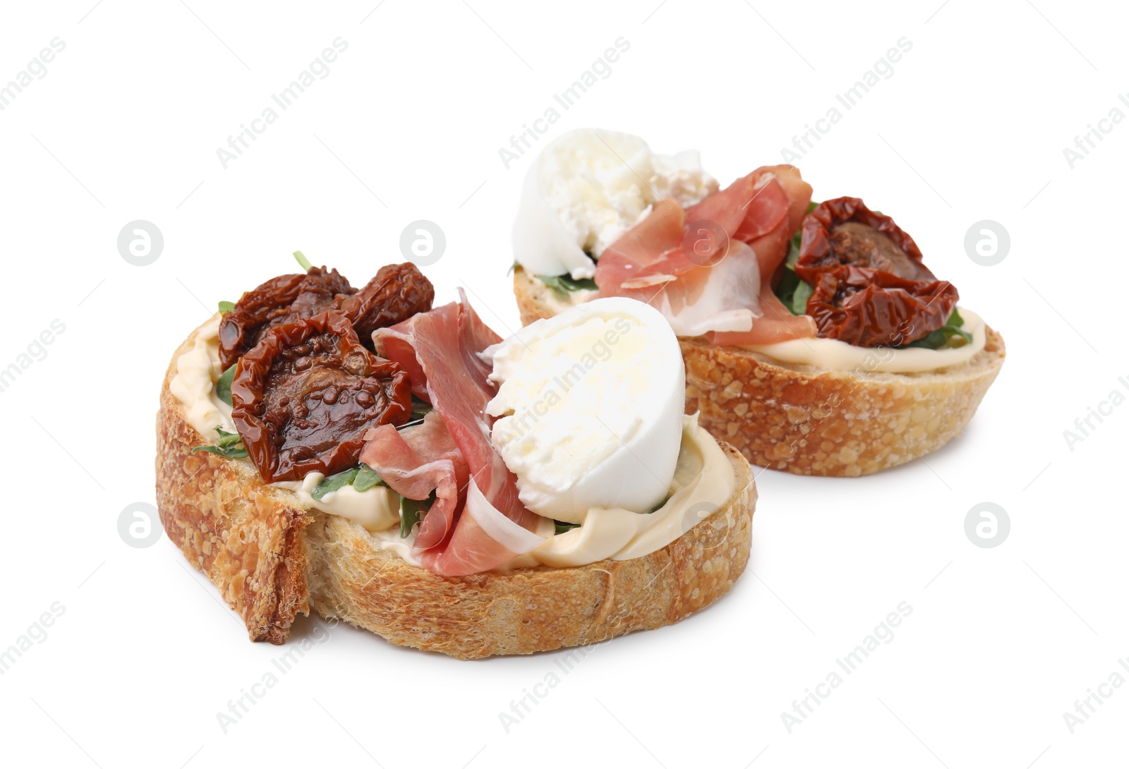 Photo of Delicious sandwiches with burrata cheese, ham and sun-dried tomatoes isolated on white