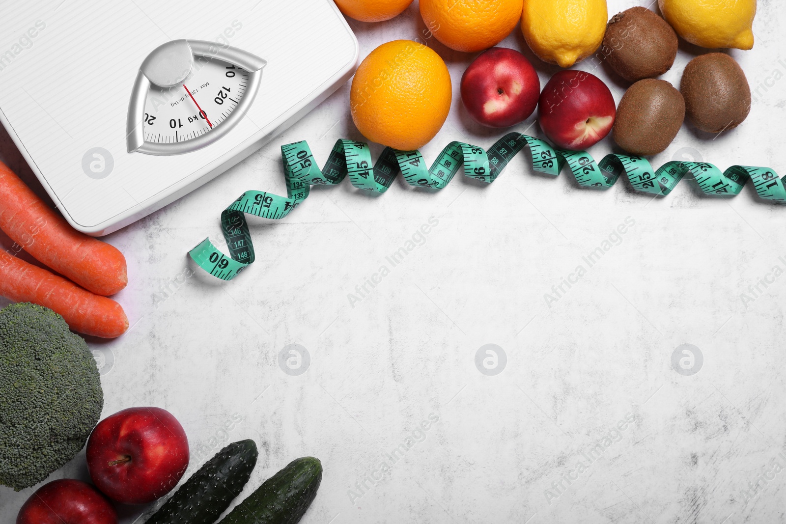 Photo of Scales, measuring tape, fresh fruits and vegetables on light gray textured table, flat lay with space for text. Low glycemic index diet