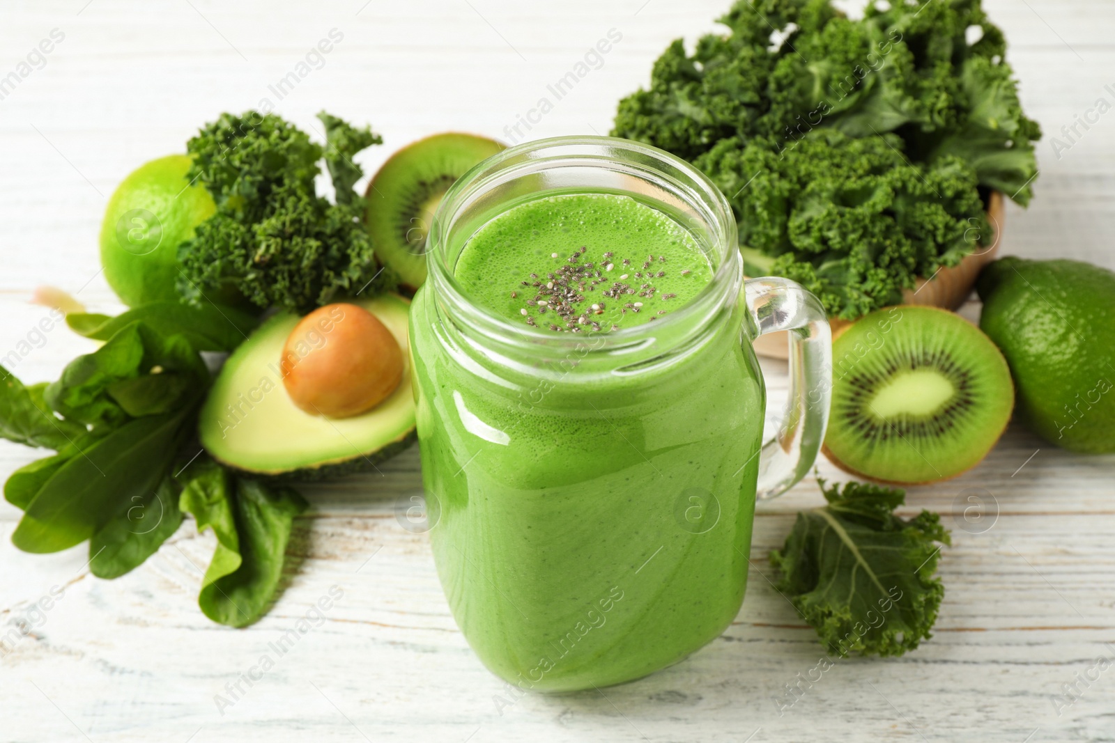 Photo of Tasty fresh kale smoothie on white wooden table