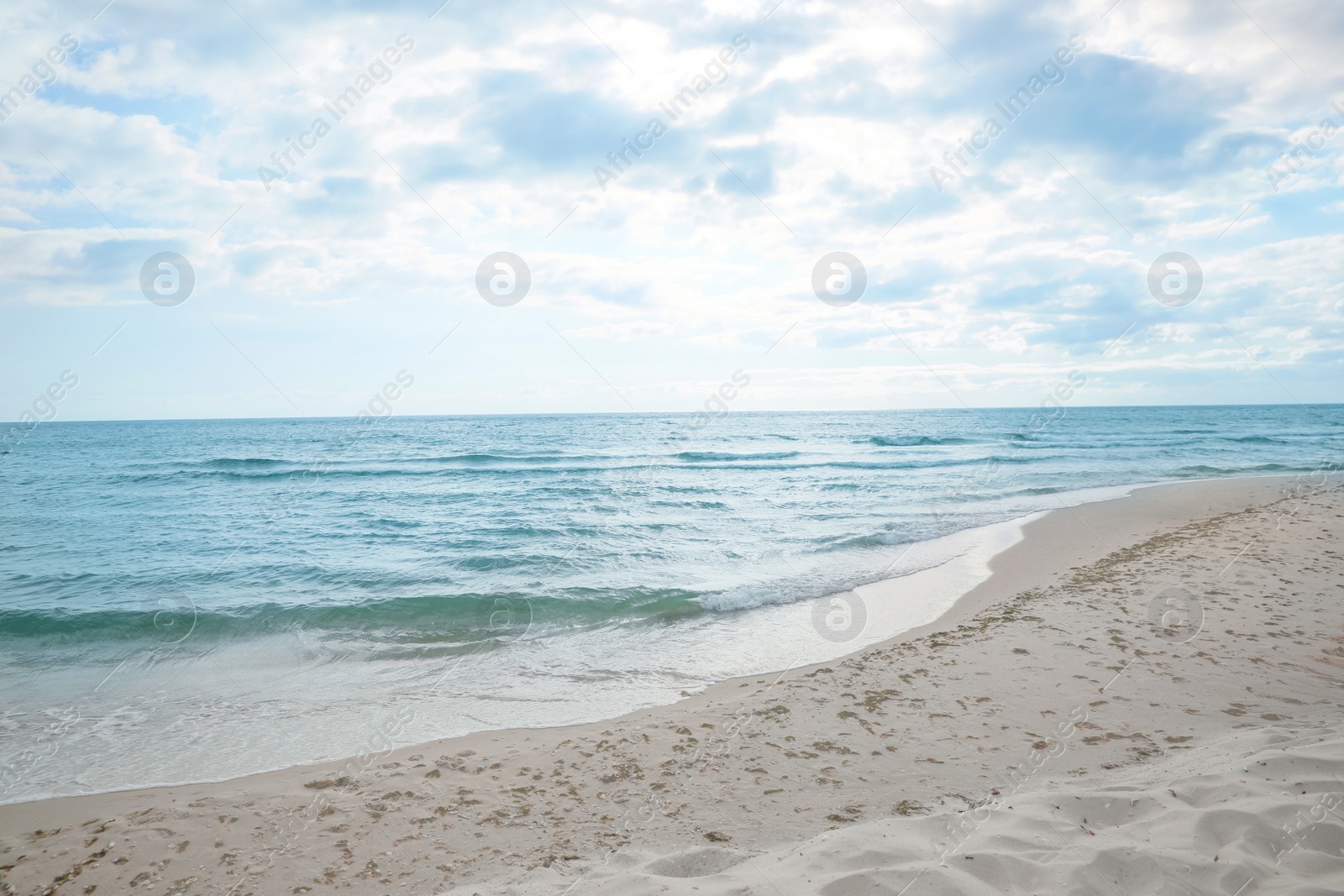 Photo of Sea waves rolling onto sandy tropical beach