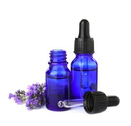 Photo of Bottles of essential oil and lavender flowers isolated on white