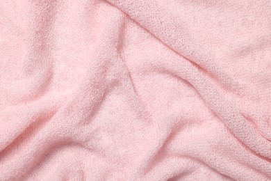 Texture of soft pink crumpled fabric as background, top view