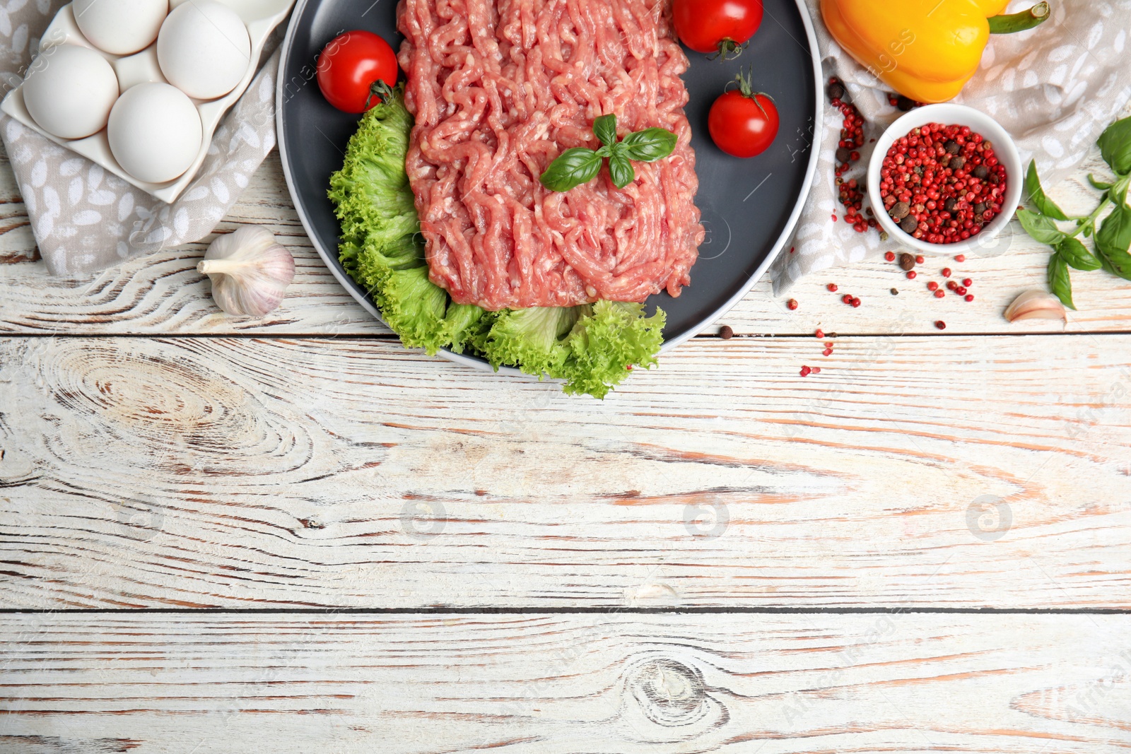 Photo of Raw chicken minced meat and ingredients on white wooden table, flat lay. Space for text