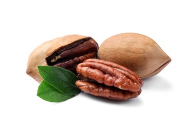 Photo of Many tasty pecan nuts with green leaves isolated on white