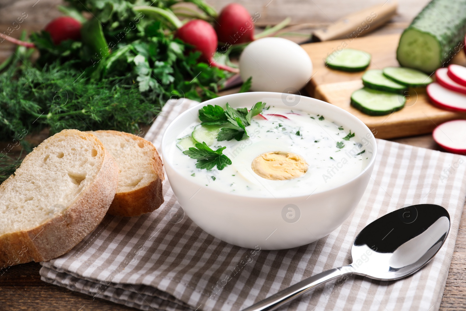 Photo of Delicious cold summer soup with kefir served on wooden table