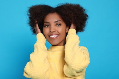 Photo of Portrait of smiling African American woman on light blue background