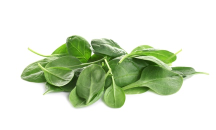 Pile of fresh green healthy baby spinach leaves on white background