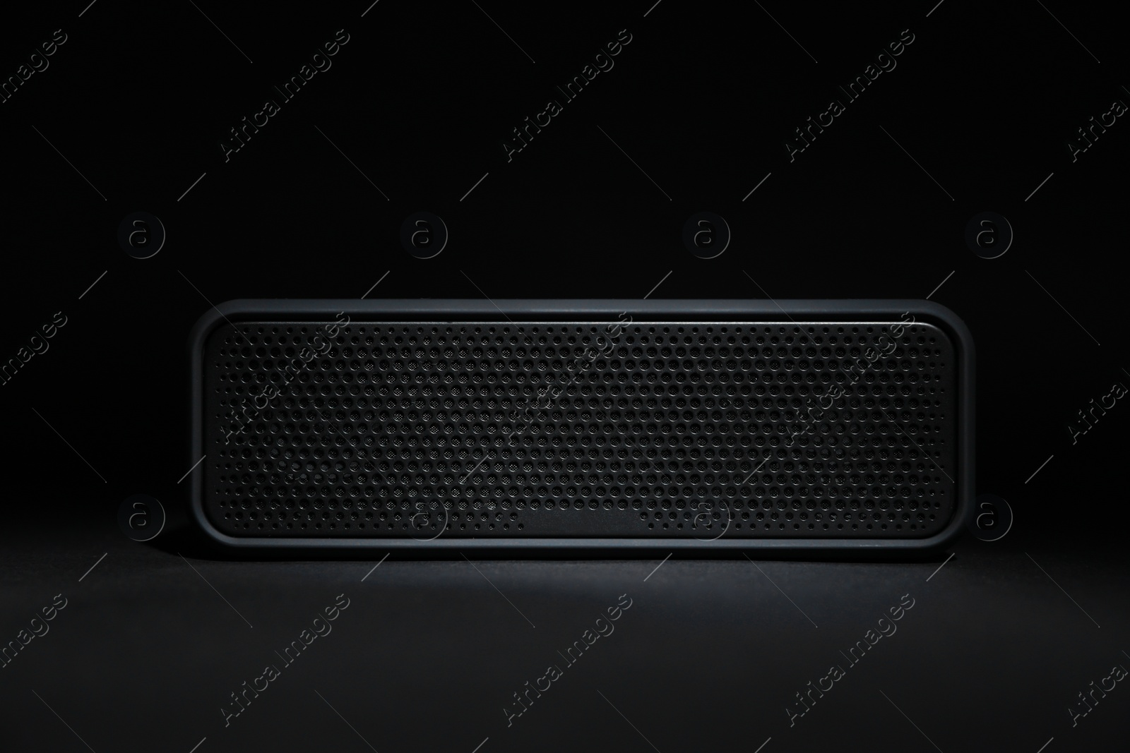 Photo of One portable bluetooth speaker on black background. Audio equipment