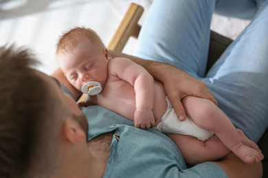Photo of Father with his newborn son, above view