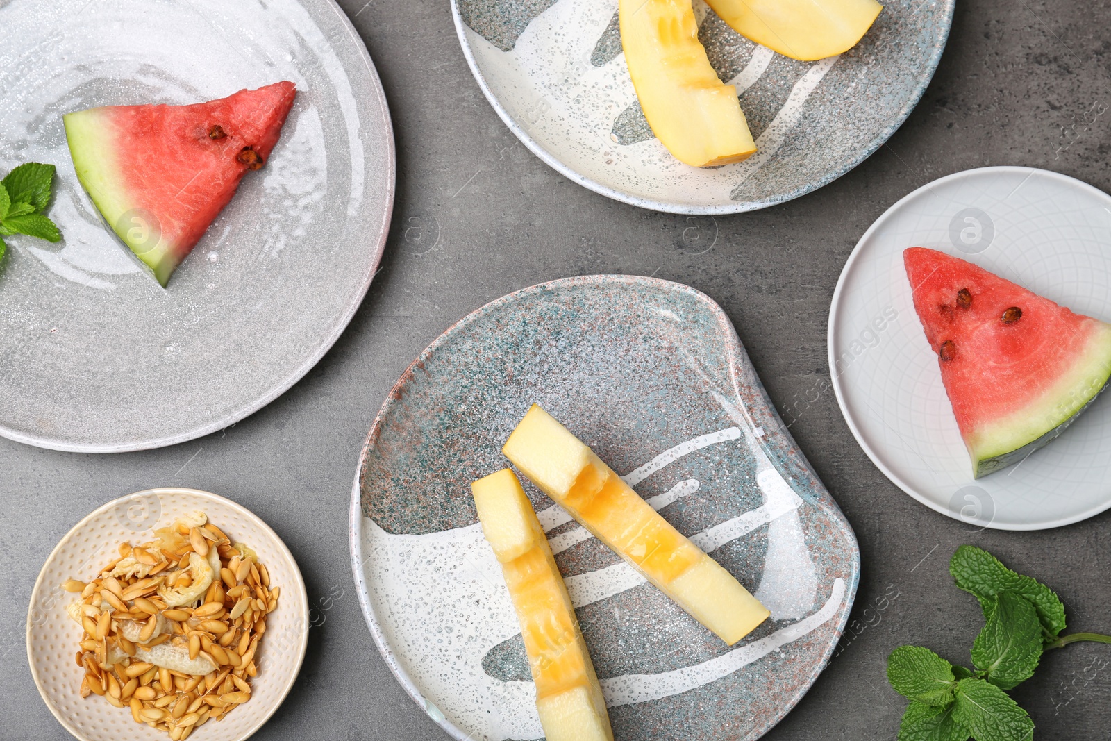 Photo of Flat lay composition with pieces of fresh melon and watermelon on table