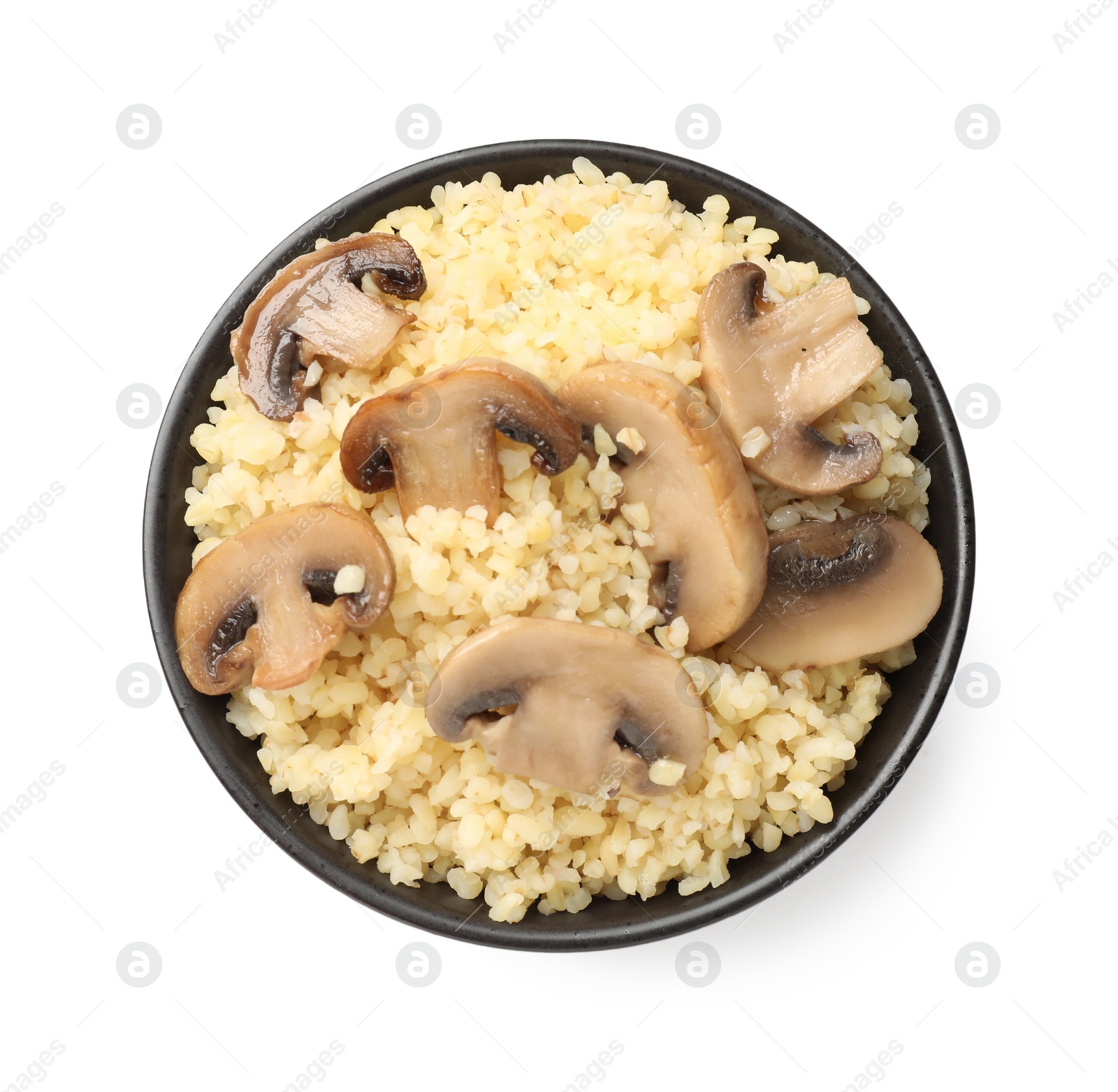 Photo of Delicious bulgur with mushrooms in bowl isolated on white, top view