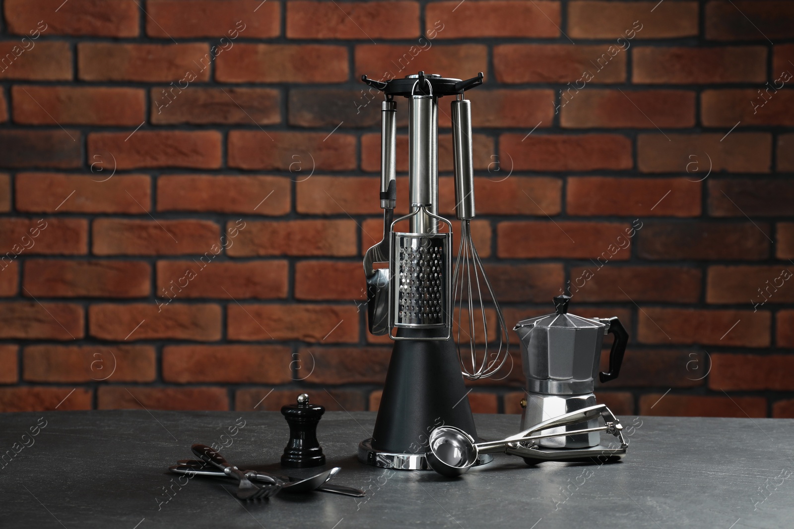 Photo of Set of different kitchen utensils on grey table