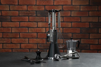 Set of different kitchen utensils on grey table