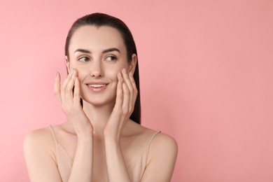 Photo of Portrait of beautiful young woman on pink background. Space for text