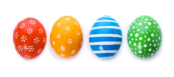 Photo of Decorated Easter eggs on white background, top view. Festive tradition