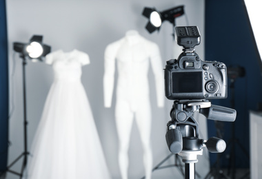 Photo of Taking pictures of ghost mannequins with modern clothes in professional photo studio, focus on camera