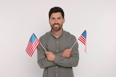 4th of July - Independence Day of USA. Happy man with American flags on white background